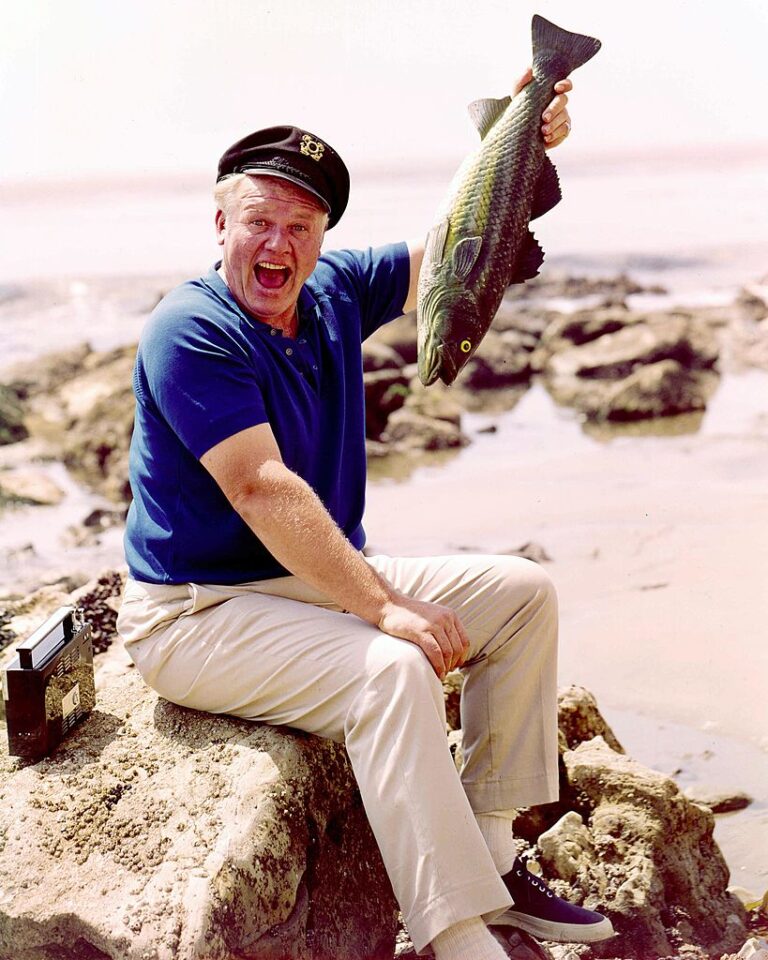 Alan Hale Jr sitting on a rock while holding up a fish in a publicity portrait for the television series ‘Gilligan’s Island’, in which Hale Jr played ‘The Skipper’, USA, circa 1967. (Photo by Silver Screen Collection/Getty Images)
