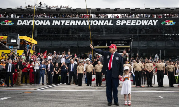 President Donald Trump, accompanied by his granddaughter Carolina Trump, greets attendees prior to riding in the Presidential limousine ahead of the start of the Daytona 500 Nascar race at Daytona International Speedway in Daytona Beach, Florida, on February 16, 2025 | Source: Getty Images

