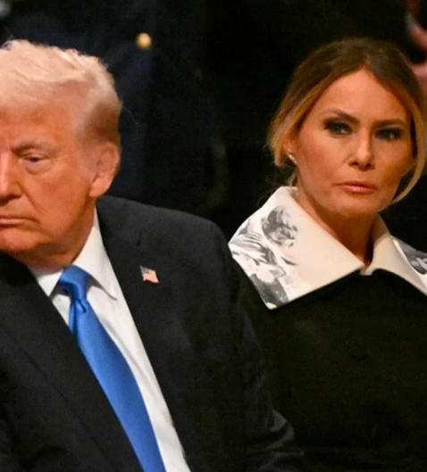 Melania Trump sitting next to Donald at Jimmy Carter's funeral with her outfit's distinct collar visible, Photo Credit: FLOTUS Report/X
